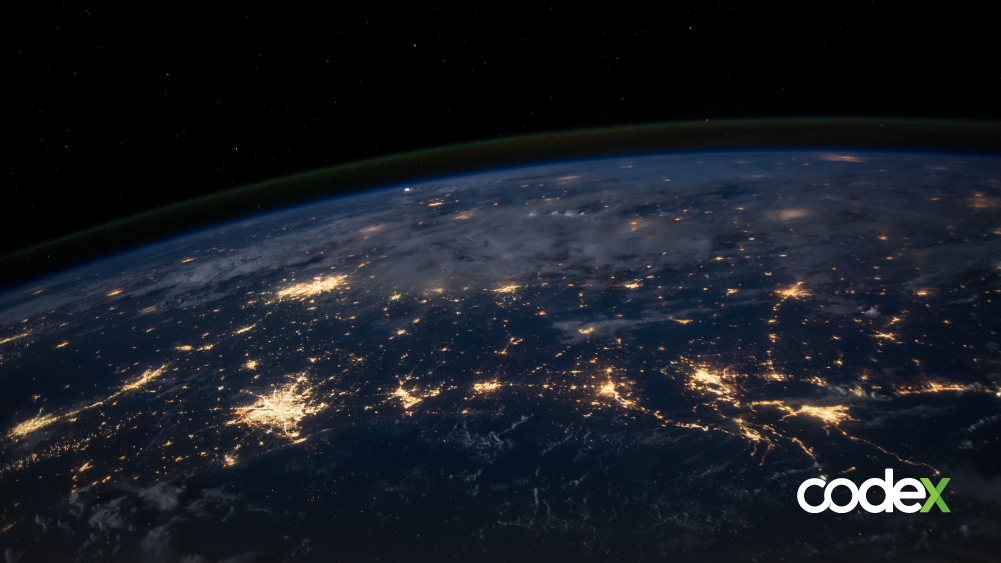 Imagem do planeta terra visto do espaço, com pequenos áreas iluminadas.